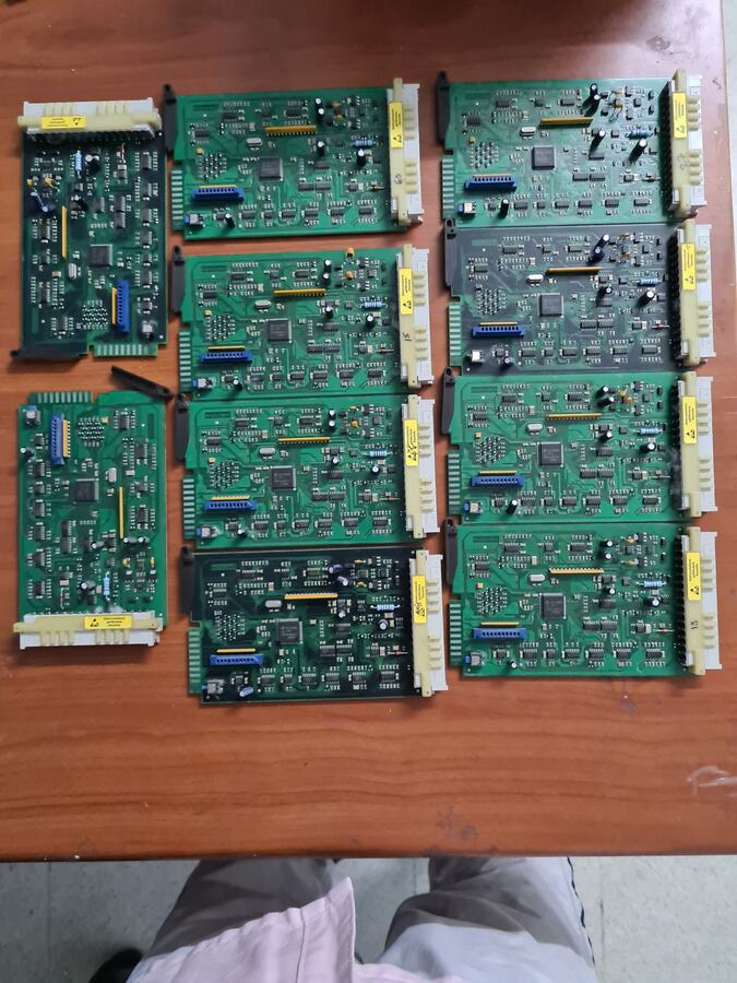 Collection of green printed circuit boards arranged on a table